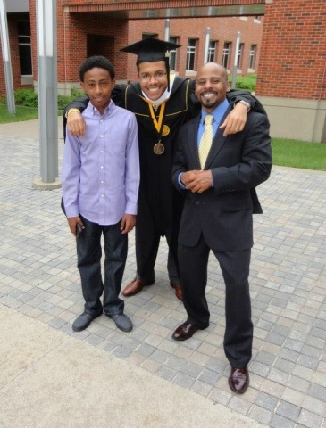 Jarvis McCowin smiles with friends at graduation