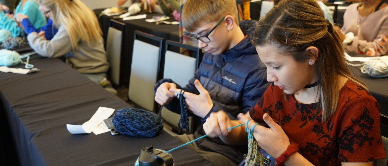 Students working with yarn