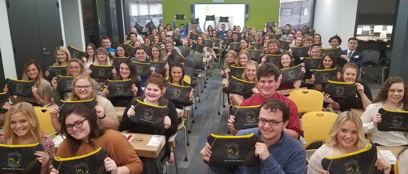Student receive Chromebooks at a ceremony