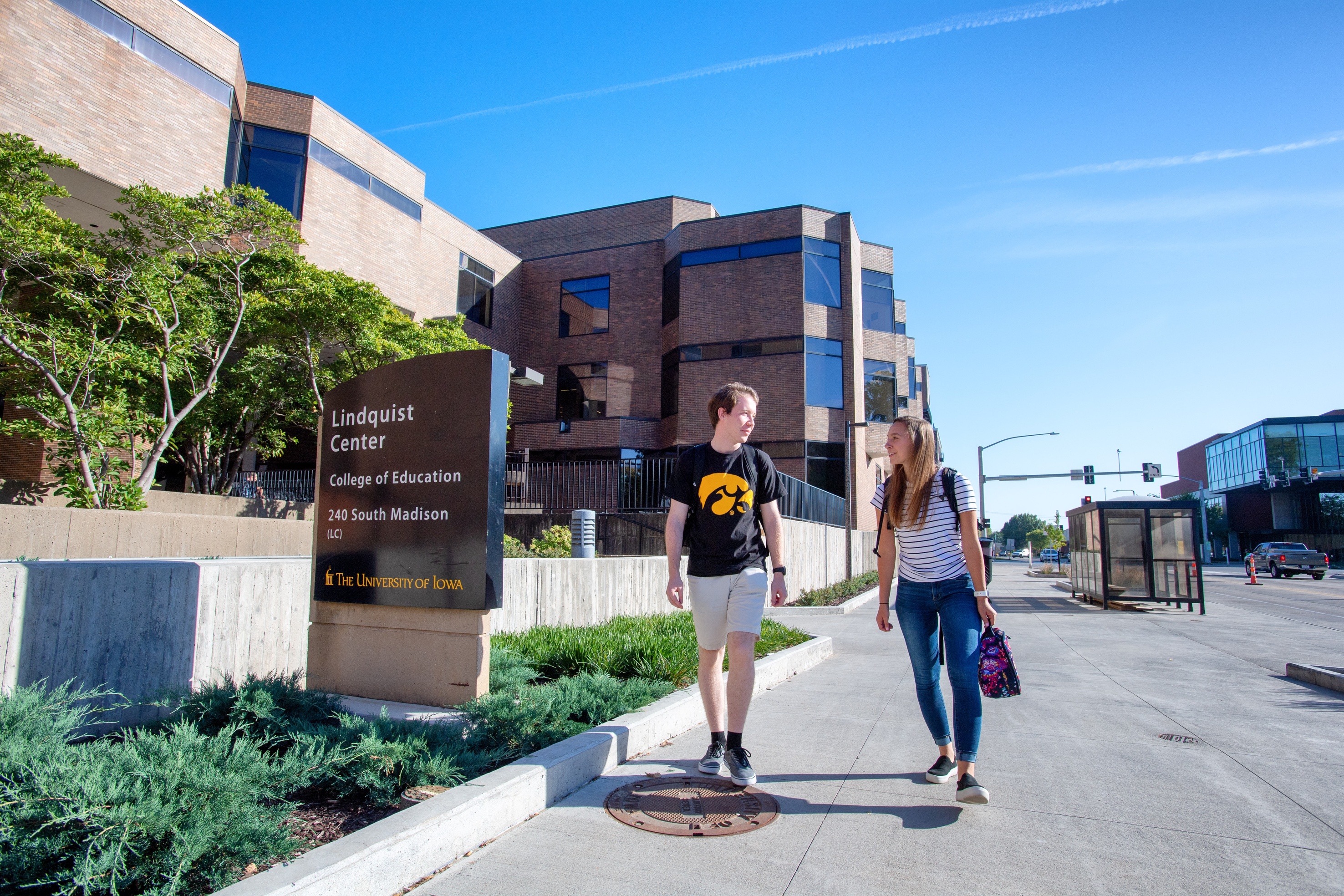 On a sunny day, students walk to the Lindquist Center.