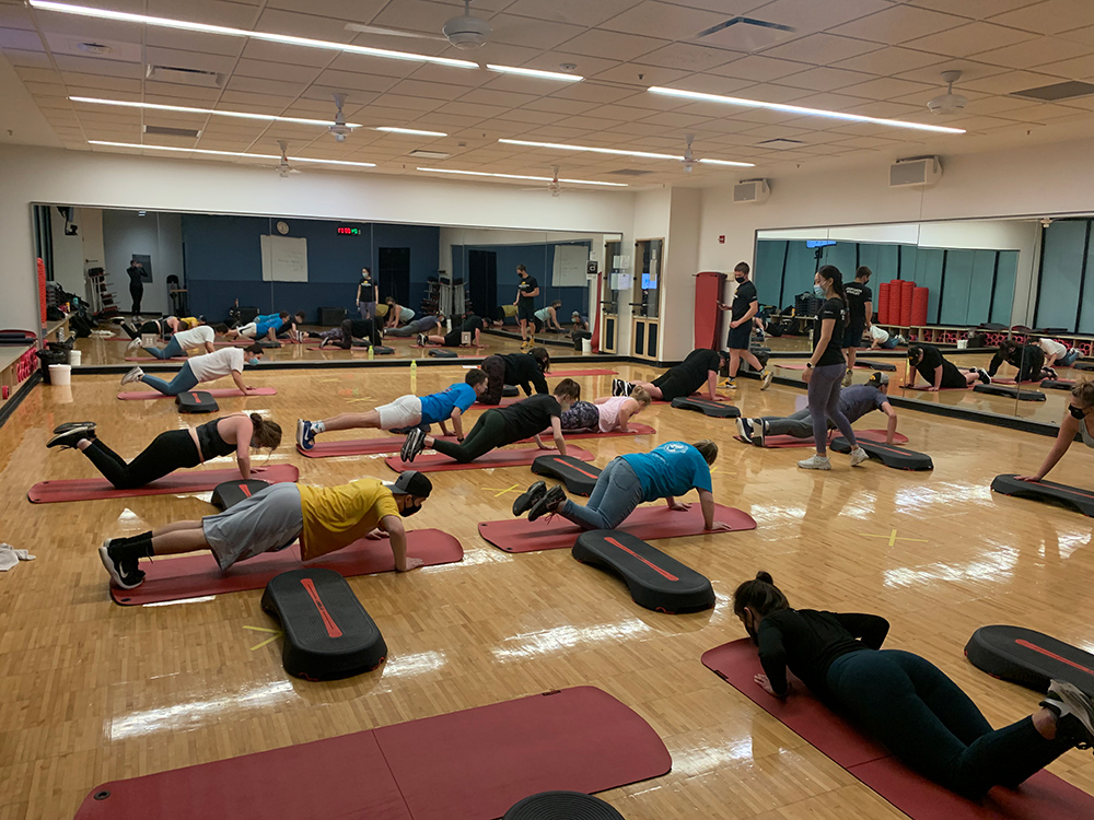 People participating an indoor fitness class.