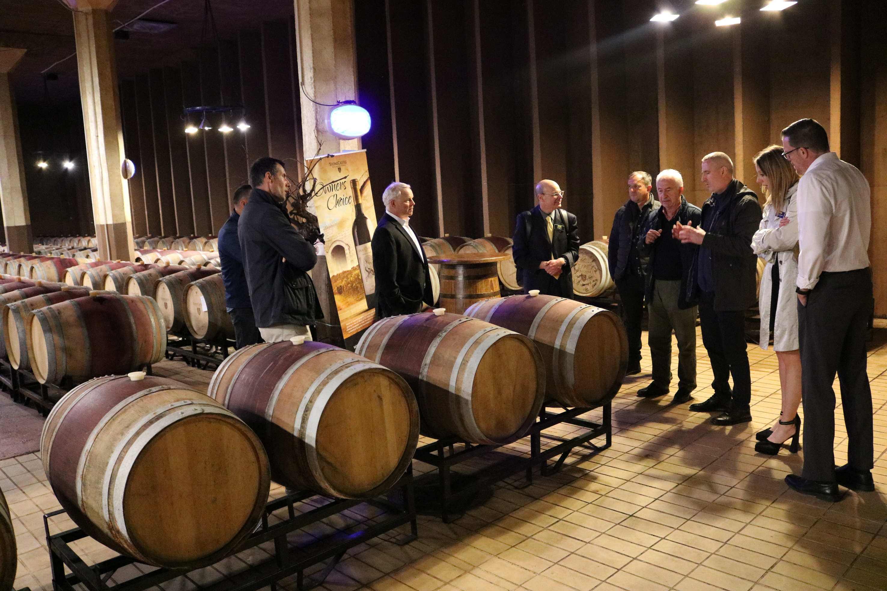 A group tours a brewery bottling plant in Kosovo.