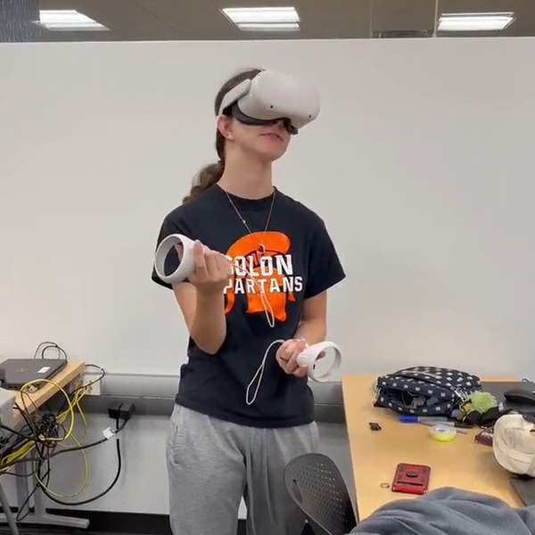 student wears a virtual reality headset in a classroom