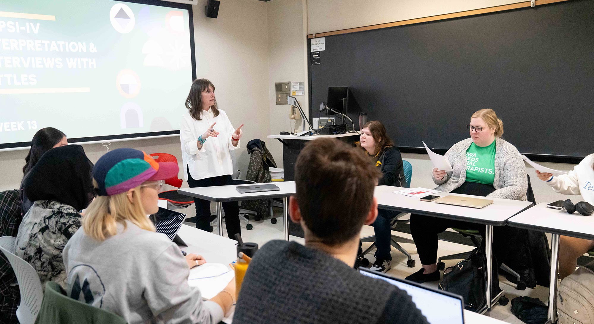 Associate Professor Amanda Case teaches in a small classroom 