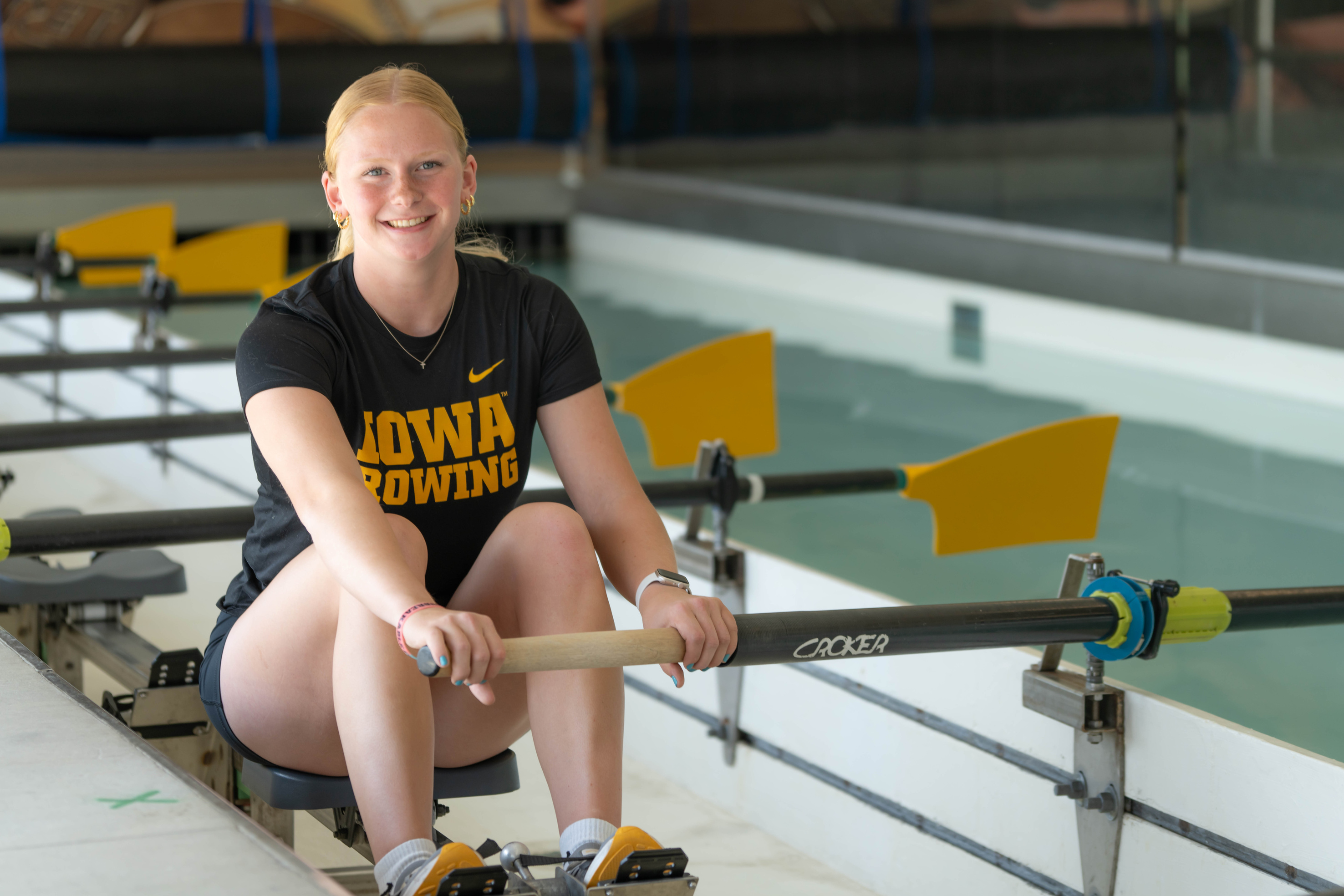 Young woman sits on rowing machine