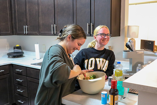 UI REACH students prepare food in their kitchen at Aspire.
