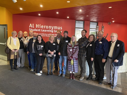 Large family poses together in front of 'Al Hieronymus" sign.