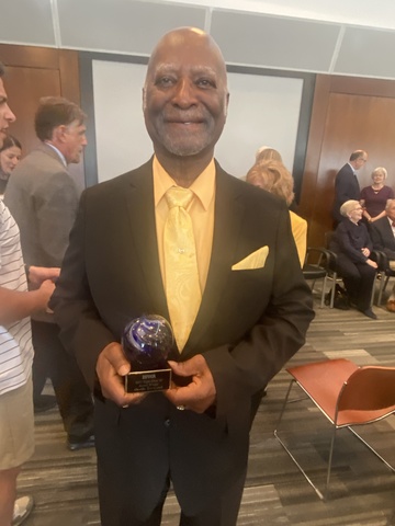 Orville Townsend holds his Eight Over 80 Award.