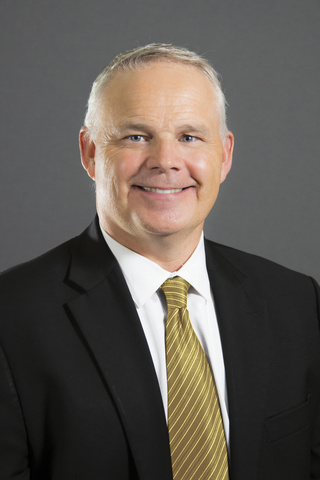 Man in suit and tie smiling