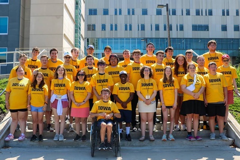 New UI REACH students stand together wearing matching UI REACH shirts.
