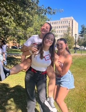Keenan smiles and poses with two of her sorority sisters