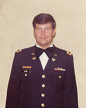 Greg Clark, younger, stands in uniform