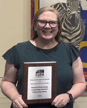 Colleen Kollash holds up award