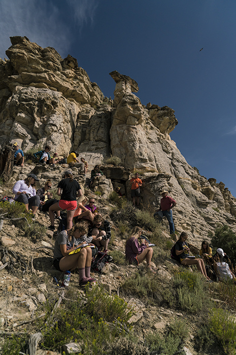 students take notes amid the mountains