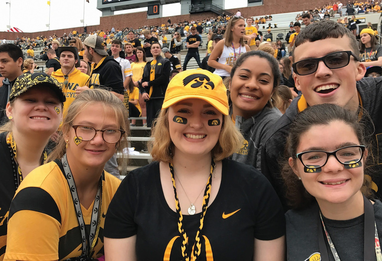Group of students smiling at a football game