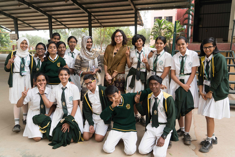 Woman with group of young students and teacher in India