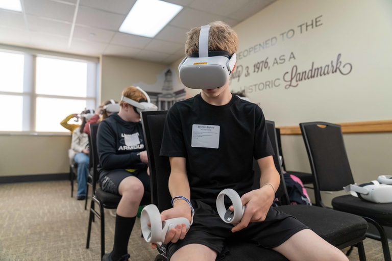 student sits with virtual reality mask on