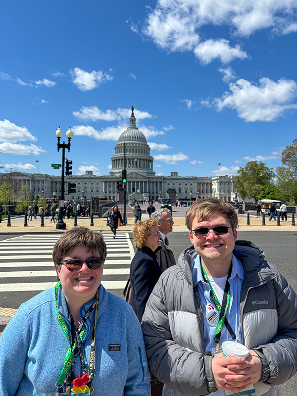 Two students stand in front of the Washington D.C. Capitol Building