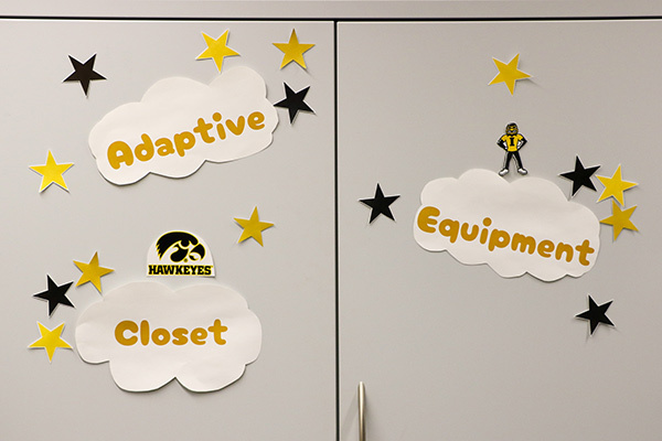Closet doors labeled with the words “Adaptive Equipment Closet