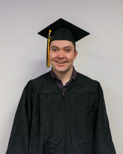 Aaron Cullen wearing a cap and gown