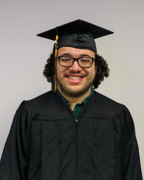 Alex Finch wearing a cap and gown