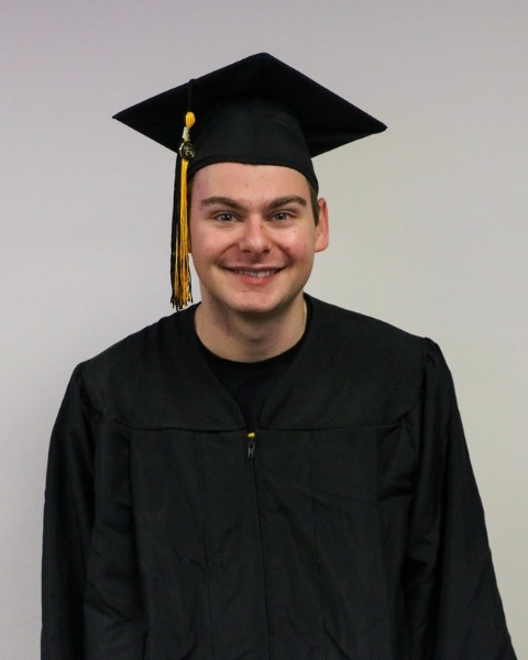 Eli Mogil wearing a cap and gown