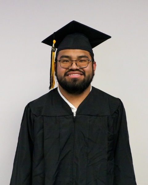Jose Peacock wearing a cap and gown