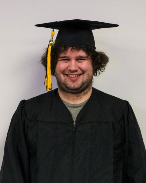 Josh Baker wearing a cap and gown