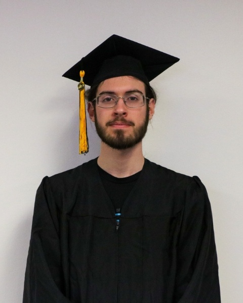 Justin Walsh wearing a cap and gown