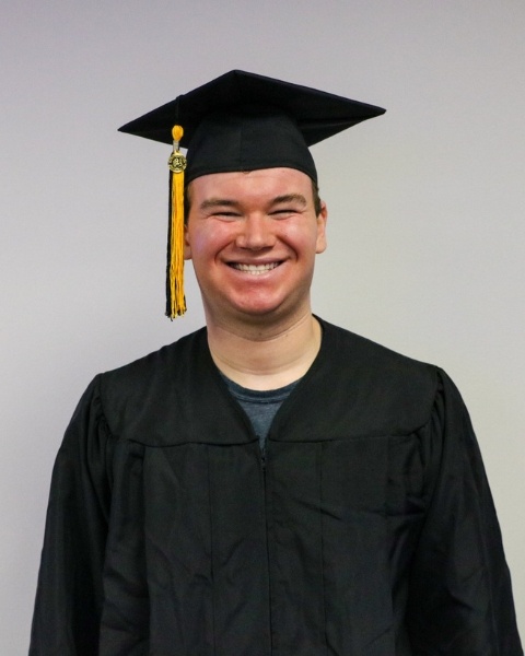 Matthew Springer wearing a cap and gown