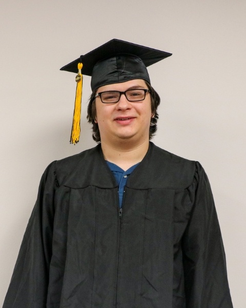 Michael Shaw wearing a cap and gown