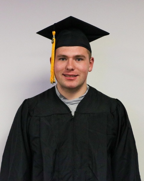 Tyler Mumm wearing a cap and gown