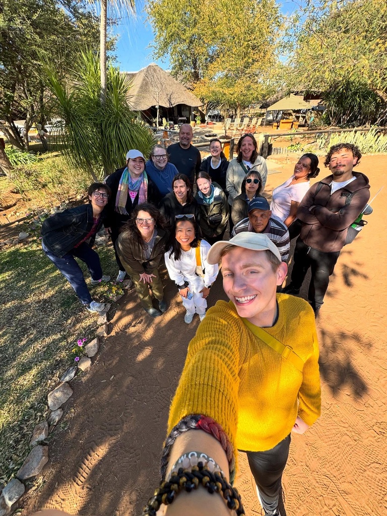 Group of people pose for photo outside