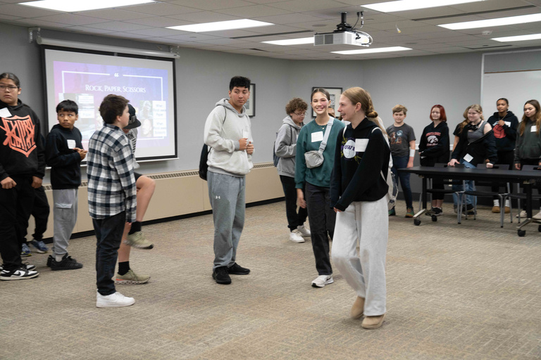Students stand in circle, smiling