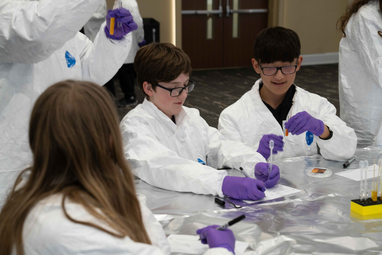 Students use pipets with different color liquids in them
