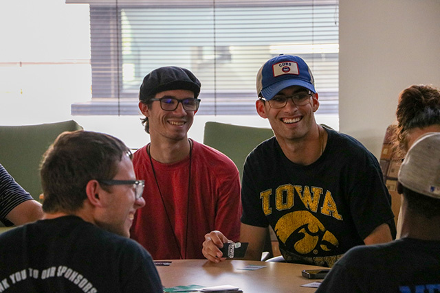 Students play a card game.