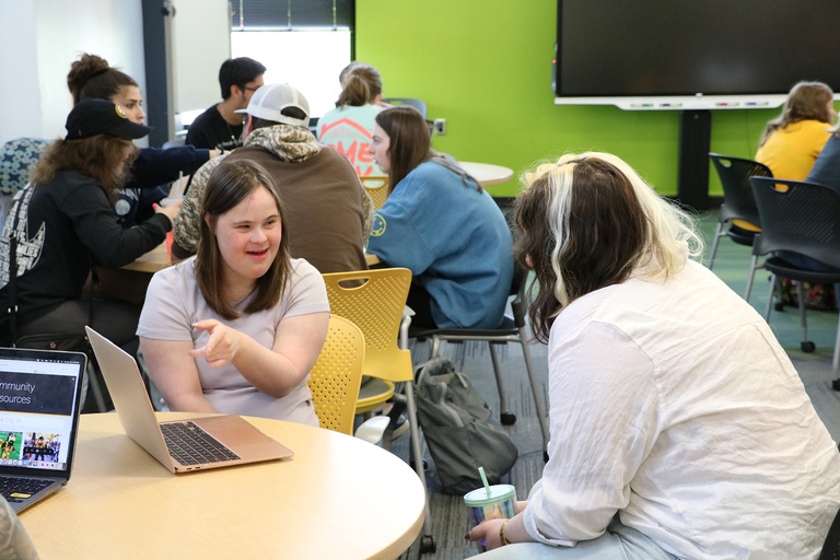 A student presents to a UI REACH staff member.