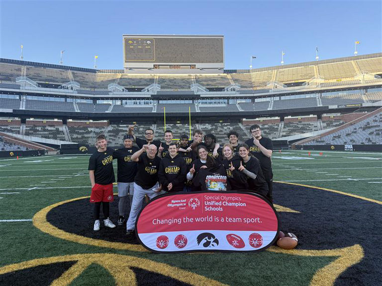 Students group together on the flag football field.
