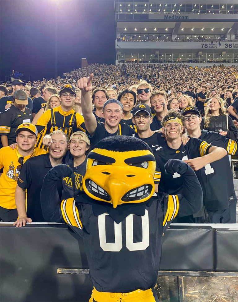 UI REACH students with Herky at a football game.