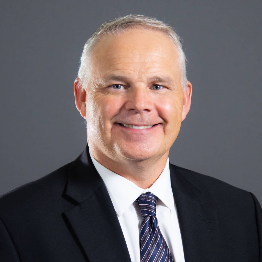 Dean Daniel Clay in suit and tie