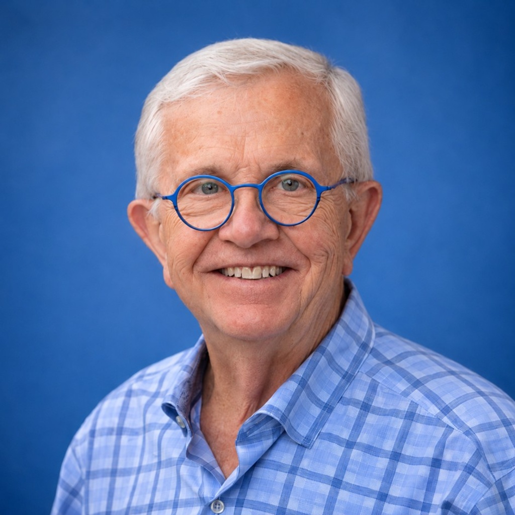 Thomas Schnack portrait wearing glasses and a plaid blue shirt