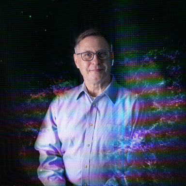 Man in glasses smiles in field of abstract galaxies