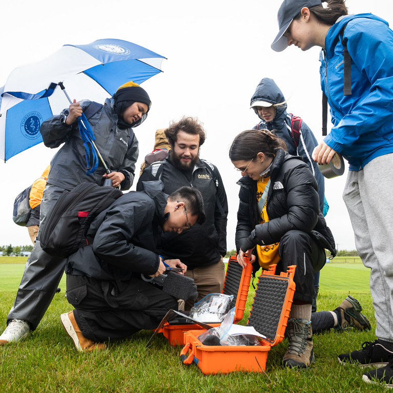 A group of students double checking their payload prior to launch