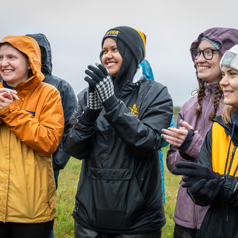 several students outside in rain gear before launch