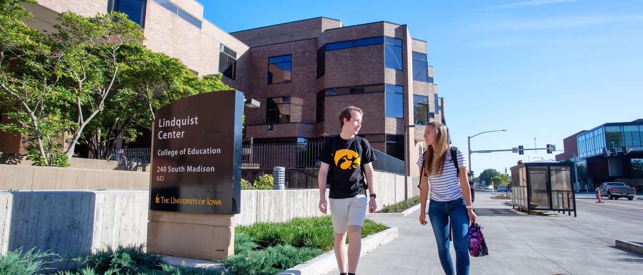 On a sunny day, students walk to the Lindquist Center.