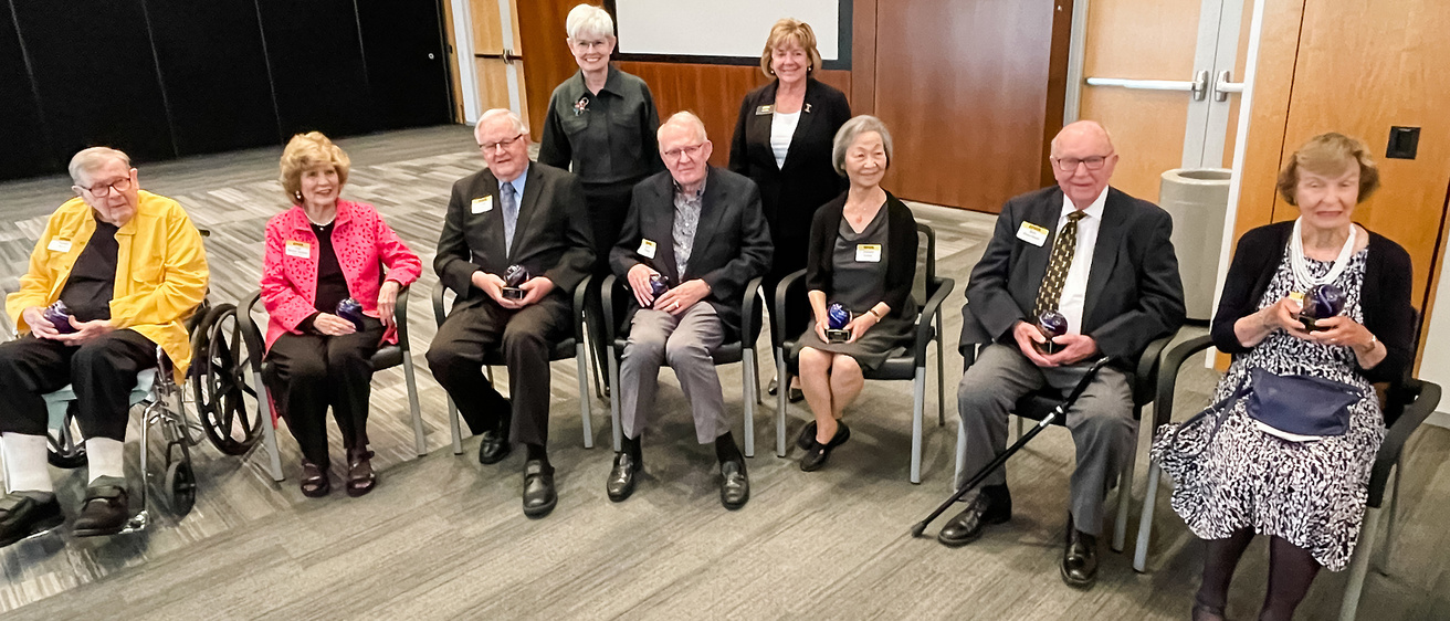 H. Dee Hoover (center) is one of Eight Over Eighty Hawkeyes honored in the inaugural celebration. He is seated in the middle of the other seven honorees, along with UI President Barbara Wilson and UI Center for Advancement President and Chief Executive OfficerLynette Marshall.
