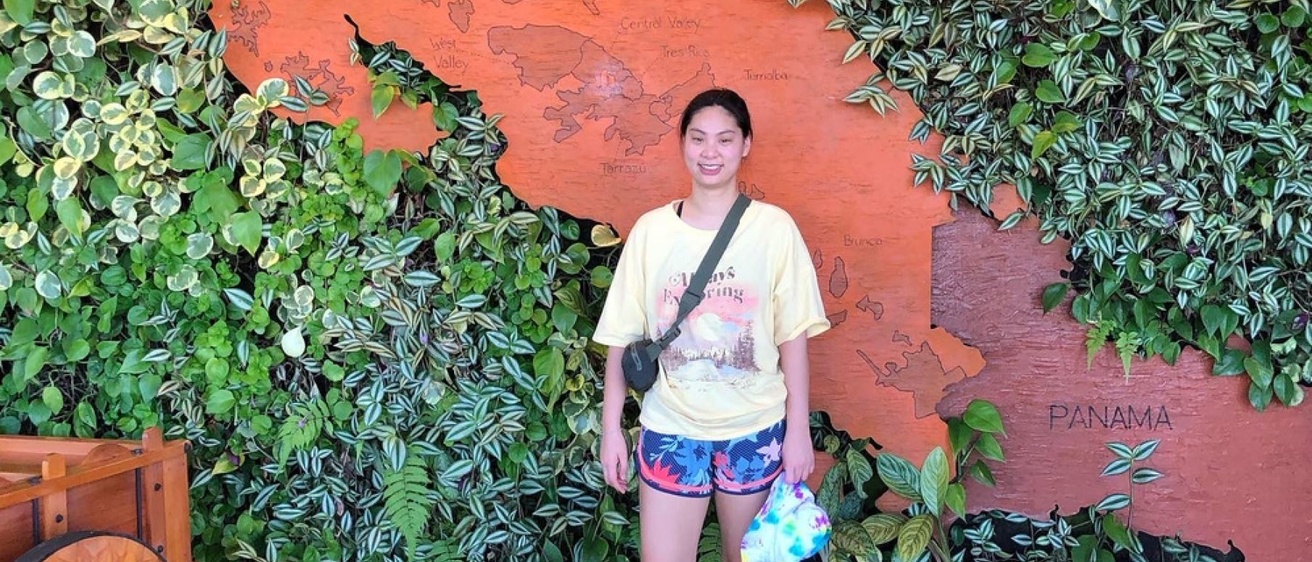 Binh Nguyen in front of a live plant wall with Panama map