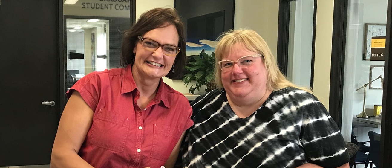 Amy Bennett and Stacy Ervin sit at a counter