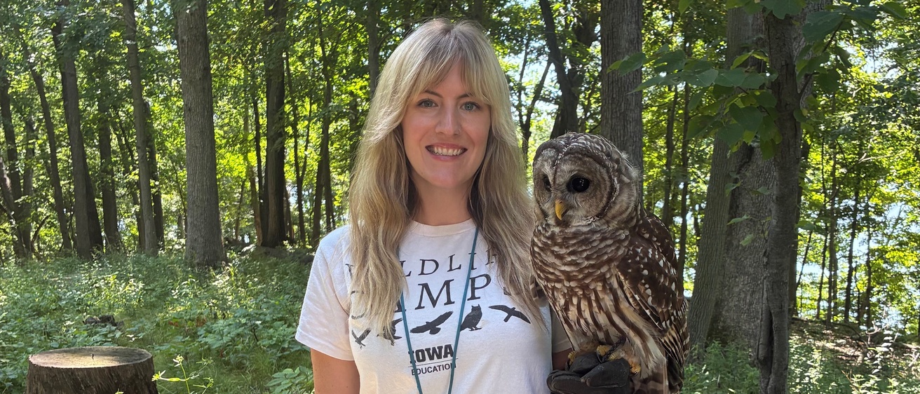 Ibsen poses with Aldo, a barred owl