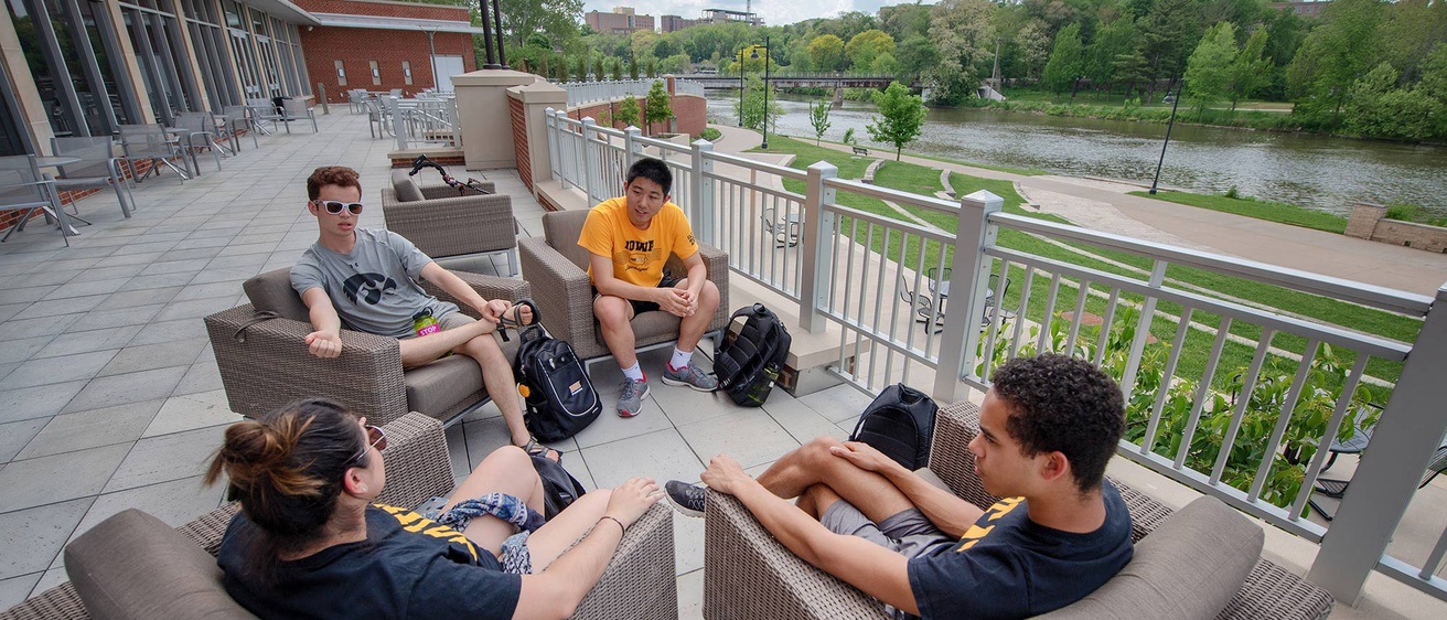 Students sitting on the patio outside of the Iowa Memorial Union 